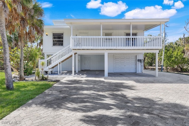 coastal home with a garage and covered porch