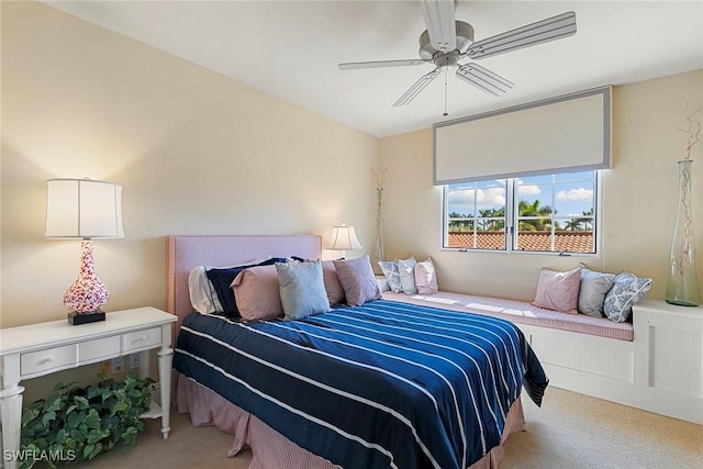 bedroom featuring a ceiling fan and light colored carpet