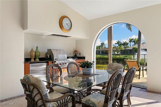 dining space featuring high vaulted ceiling