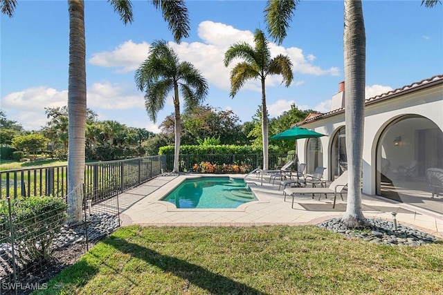 view of pool featuring a patio, a yard, fence, and a fenced in pool