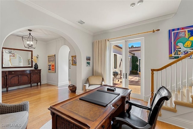 office area featuring arched walkways, visible vents, baseboards, light wood-type flooring, and crown molding