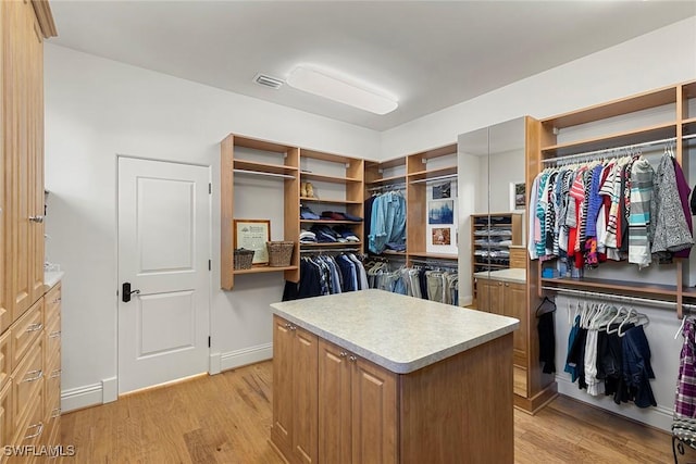 walk in closet with light wood-style flooring and visible vents