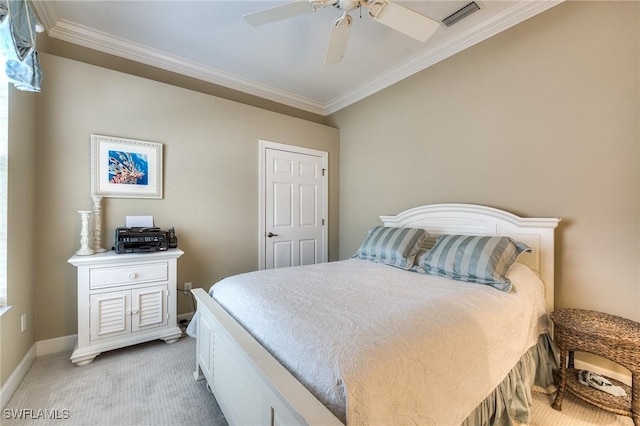 carpeted bedroom featuring crown molding and ceiling fan