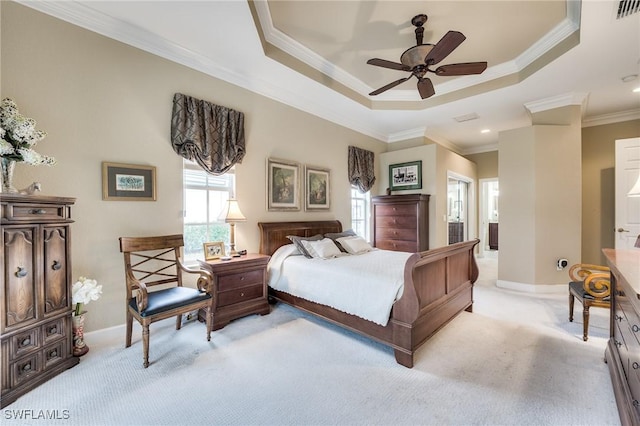 carpeted bedroom with a raised ceiling and crown molding