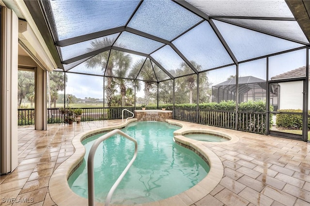 view of pool featuring an in ground hot tub, a patio, and glass enclosure