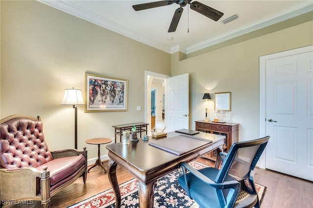 office area featuring crown molding, light hardwood / wood-style flooring, and ceiling fan