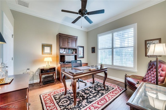 office area featuring ceiling fan, ornamental molding, and light hardwood / wood-style flooring