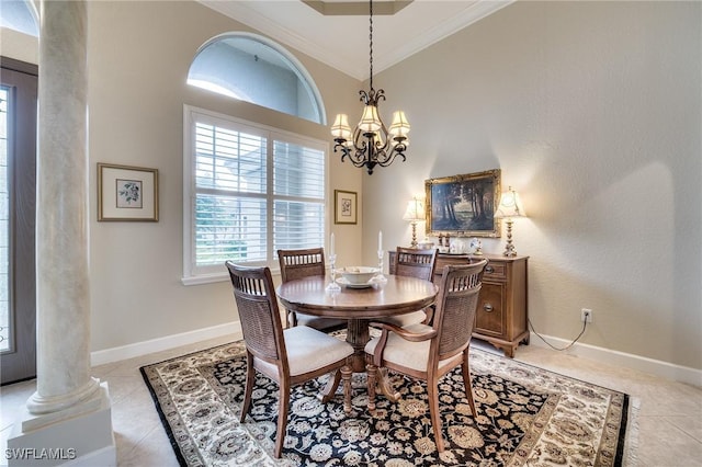 tiled dining space with ornate columns, crown molding, and an inviting chandelier