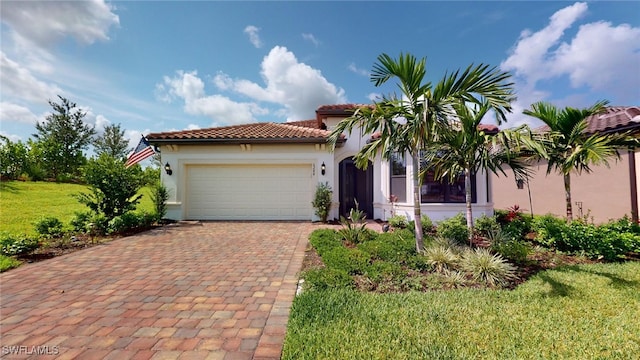 mediterranean / spanish-style home with a garage and a front yard