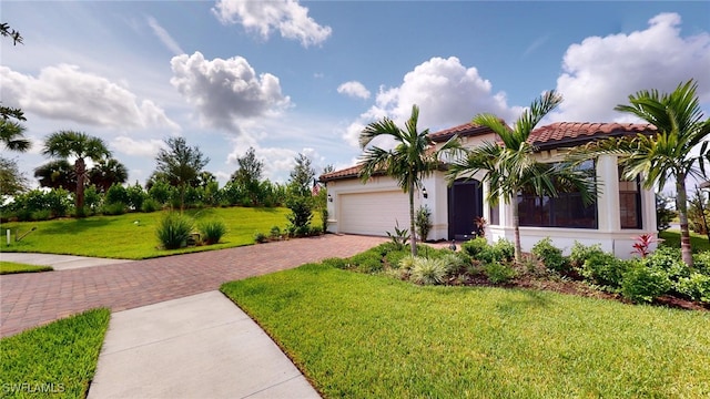 view of front of property with a garage and a front lawn