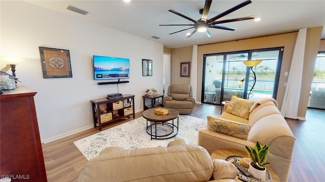 living room with ceiling fan and wood-type flooring