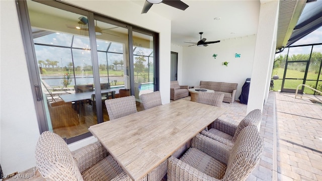 interior space featuring a water view and ceiling fan