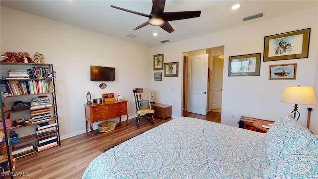 bedroom with hardwood / wood-style floors and ceiling fan