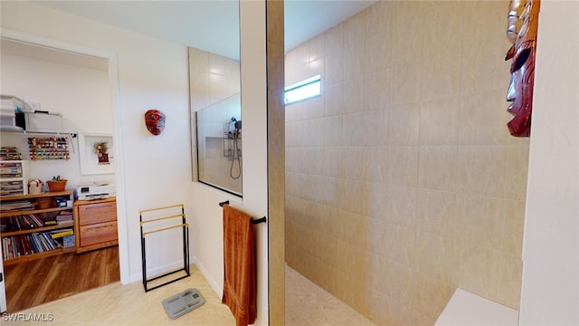 bathroom featuring tile patterned flooring and a shower