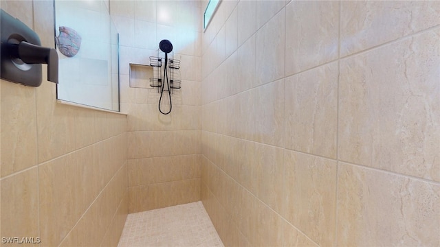 interior details with a tile shower