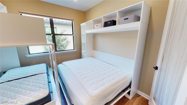 bedroom with wood-type flooring