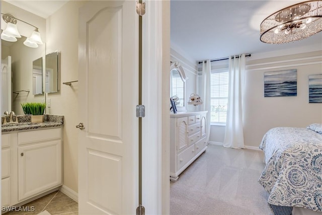 bedroom featuring sink and light carpet