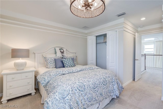 bedroom with light colored carpet and an inviting chandelier