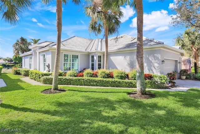 view of front of property with a garage and a front yard