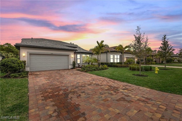 view of front of house with a lawn and a garage