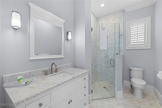 full bathroom with toilet, a stall shower, baseboards, and vanity