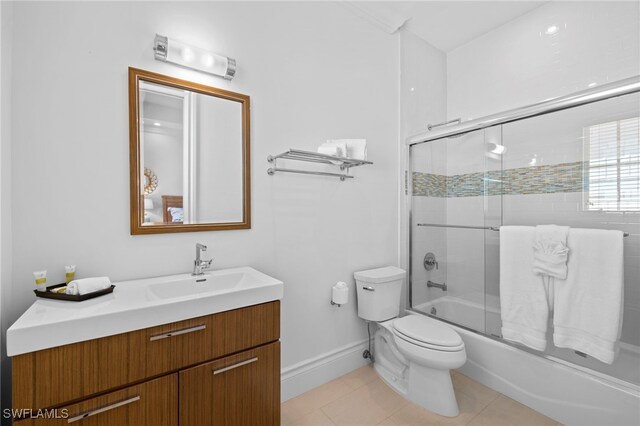 full bathroom with enclosed tub / shower combo, vanity, tile patterned floors, and toilet