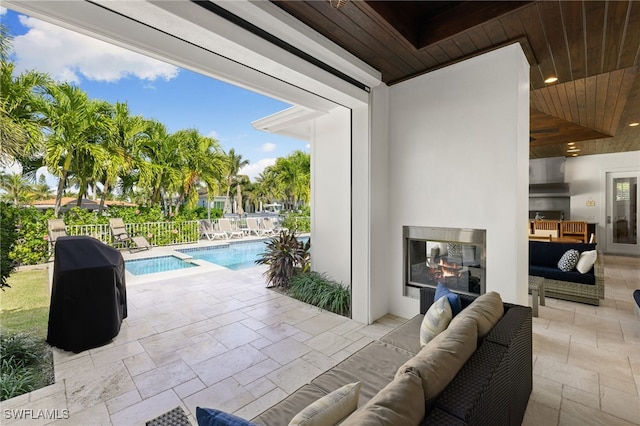 view of patio / terrace with fence, an outdoor living space, and a fenced in pool