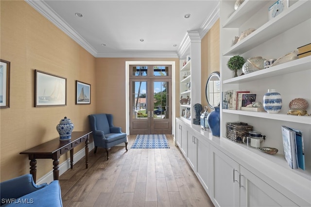 hall with french doors, ornamental molding, light hardwood / wood-style floors, and built in features