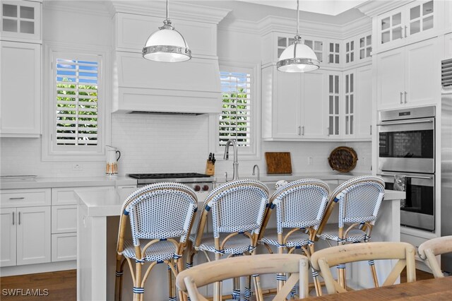 kitchen with white cabinetry, pendant lighting, and decorative backsplash