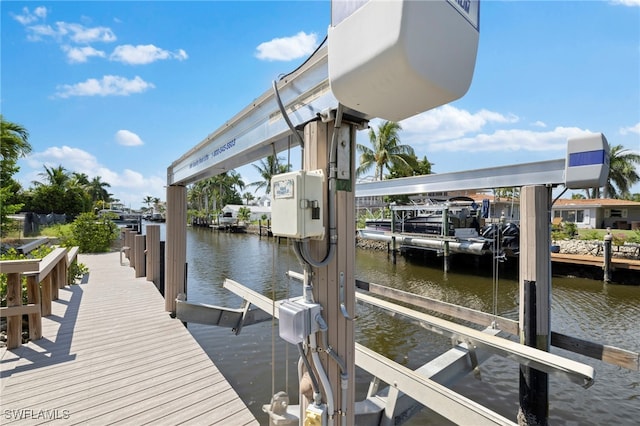 view of dock with a water view and boat lift