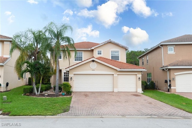 mediterranean / spanish-style home featuring a garage and a front yard