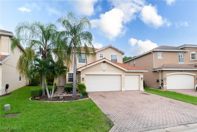 view of front of home with a garage and a front lawn