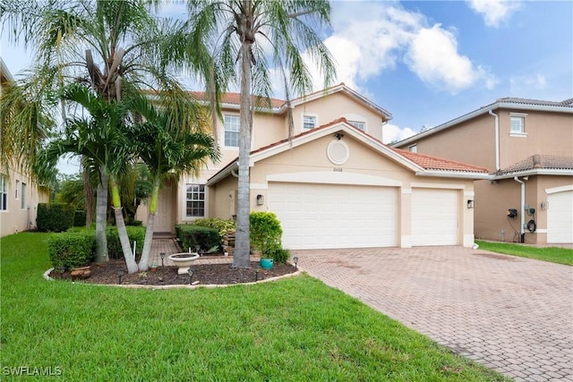 mediterranean / spanish-style house featuring a front yard