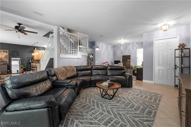 tiled living room with ceiling fan