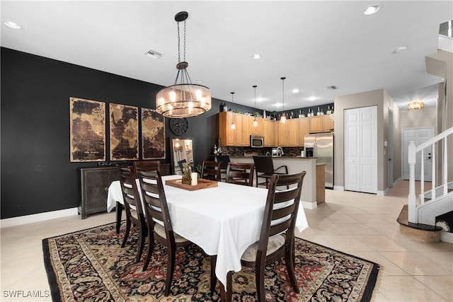 tiled dining area with a notable chandelier