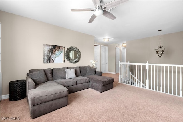 carpeted living room with a notable chandelier