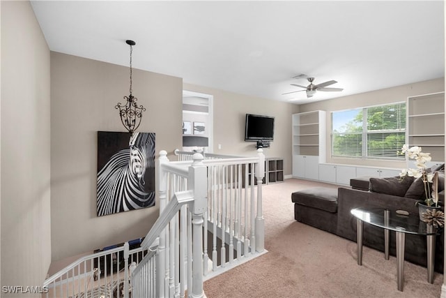 carpeted living room with ceiling fan