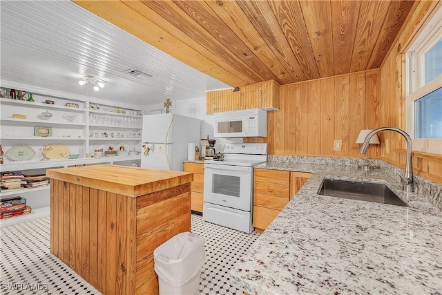 kitchen featuring sink, white appliances, light stone countertops, built in shelves, and wooden ceiling