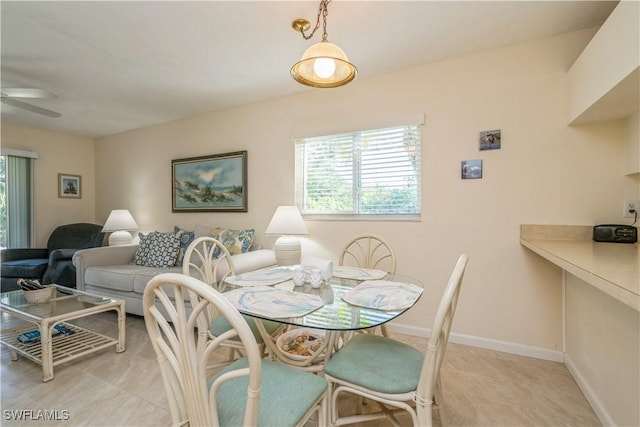 dining room with ceiling fan, a healthy amount of sunlight, and light tile patterned flooring