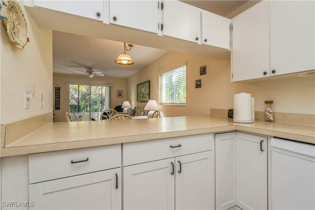 kitchen featuring dishwasher, ceiling fan, hanging light fixtures, white cabinets, and kitchen peninsula