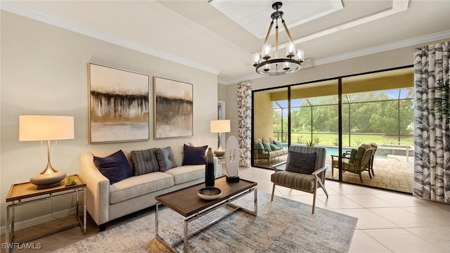 living room with a chandelier, a raised ceiling, ornamental molding, and light tile patterned flooring