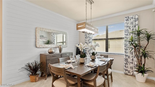 dining area with crown molding and light tile patterned floors