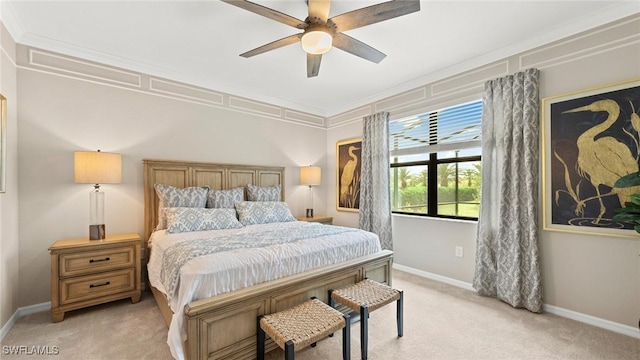 bedroom featuring ceiling fan, ornamental molding, and light carpet