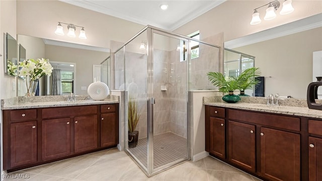 bathroom with crown molding, a shower with door, tile patterned floors, and vanity