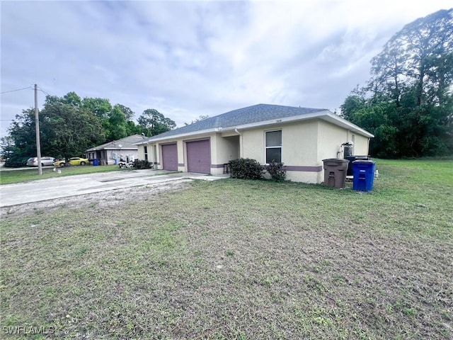 ranch-style home with a garage and a front yard