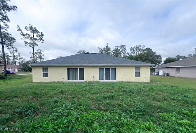 back of house featuring a yard