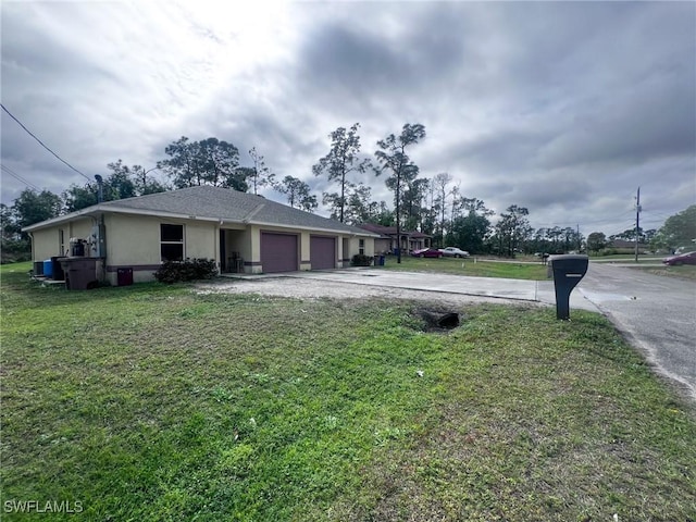 view of front of property with a garage and a front lawn