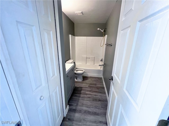 bathroom with shower / tub combination, vanity, toilet, wood finished floors, and visible vents