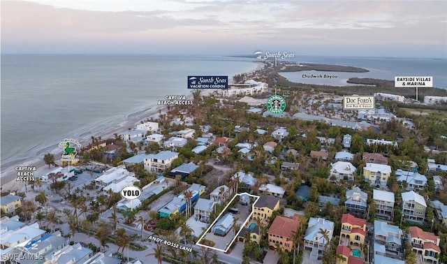 aerial view at dusk featuring a water view