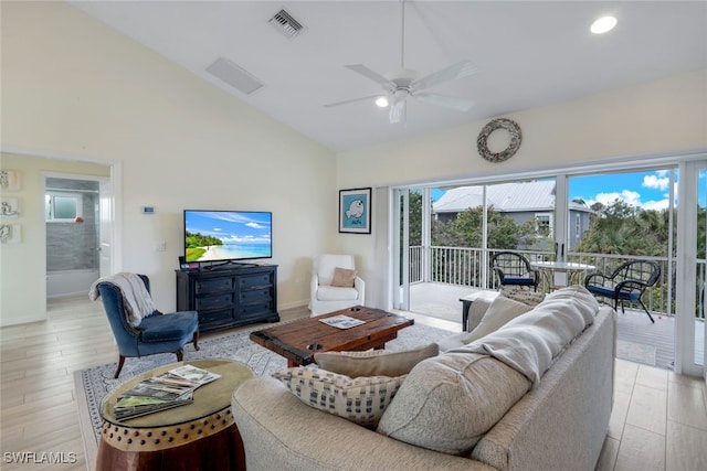 living room featuring lofted ceiling, light hardwood / wood-style flooring, and ceiling fan